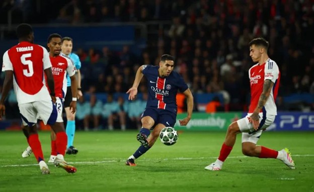 PSG’s Achraf Hakimi dribbles past Arsenal defenders during the UEFA Champions League semi-final match.