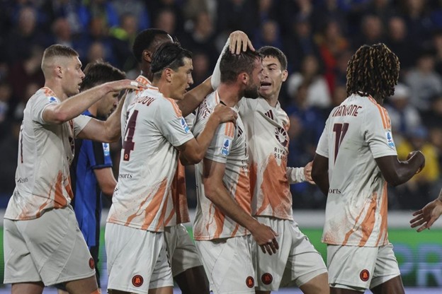AS Roma players celebrate a goal during a match.