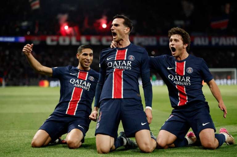 Paris Saint-Germain stars cheer after scoring in Champions League clash.