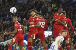 Liverpool players react to a free-kick during a Premier League match against Brighton.