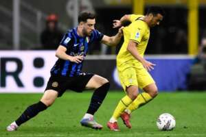 Inter Milan defender challenges Lazio forward Pedro during a Serie A match, with both players battling for possession.