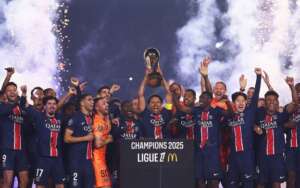 Paris Saint-Germain players celebrate on stage after winning the 2024/25 Ligue 1 title.
