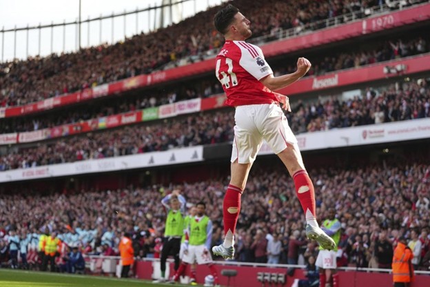 Declan Rice celebrates with a powerful mid-air fist pump after scoring a goal for Arsenal